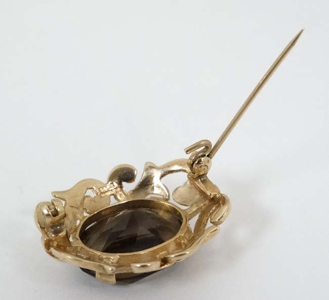 A 9ct gold brooch set with central facet cut smokey quartz within a scrolling mount. - Image 2 of 5