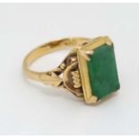 A Chinese 22ct gold ring set with jade like hardstone stone to top CONDITION: Please