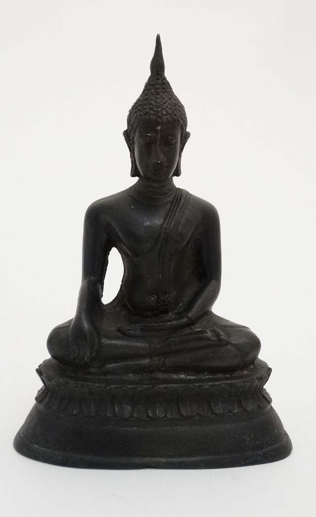 An Oriental cased patinated bronze figure of a seated buddaha on lotus flower base,