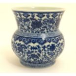 A small squat Chinese blue and white fengweizun / yen-yen vase, having scrolling floral decoration,