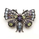 A yellow and white metal brooch formed as a butterfly set with a profusion of stones including