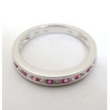 An 18ct white gold diamond and ruby half eternity ring CONDITION: Please Note - we