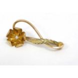 A gilt metal brooch with floral decoration set with seed pearl to flower head.