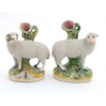 A pair of late 19thC spill vases formed as a ewe and a ram standing over streams . 7 1/4'' high.