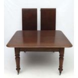 A Victorian mahogany 2-leaf dining table extending to approx 86" x 54" wide