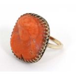 A 14k gold ring set with carved low relief coral cameo to centre CONDITION: Please