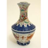 A Chinese blue and white baluster vase decorated in polychrome enamels with 5 clawed dragons