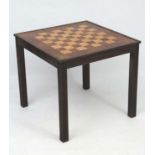 Art Deco : a Macassar Ebony satinwood and walnut Games table , standing on four grooved legs,