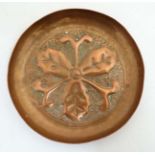 Manner of Newlyn / Keswick school : An embossed copper dish with oak leaf decoration.