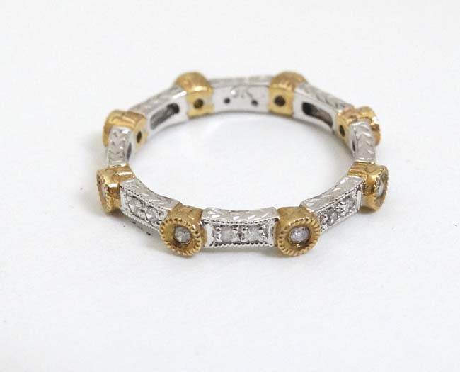 A 9ct white and yellow gold ring set with diamonds CONDITION: Please Note - we do