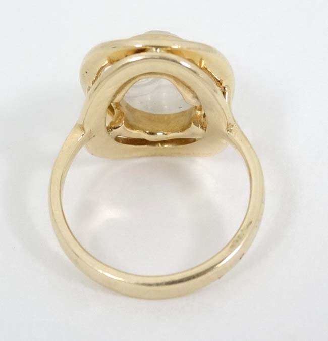 A 14k gold ring set with moonstone cabochon with man in the moon style face decoration. - Image 3 of 4