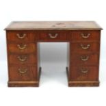 A c.1800 mahogany pedestal desk with gold tooled leather insert to top.