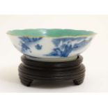 A blue and white Chinese shallow bowl on wooden stand ,
