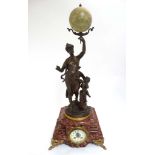 French Mantle Clock : an Anfrie " La Terre " bronzed spelter figure holding a terrestrial globe