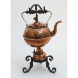 Arts & Crafts : A wrought iron copper and brass spirit kettle and stand,