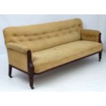 A Continental late Victorian oak framed button back settee.