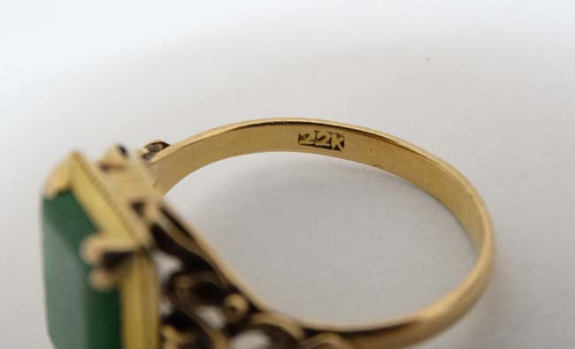 A Chinese 22ct gold ring set with jade like hardstone stone to top CONDITION: Please - Image 3 of 6