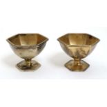 A pair of silver gilt salts of hexagonal pedestal form.