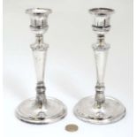A pair of silver candlesticks hallmarked Birmingham 1985 maker B&Co.