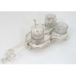 A novelty silver plate cruet stand formed as a violin with three cut glass cruets 9" long