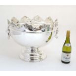 An impressive large pedestal silver plate wine cooler with lions mask handles.