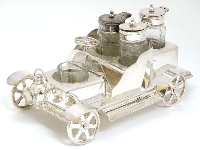 A novelty silver plate cruet set comprising 4 cruet bottles in stand formed as a vintage car. 21stC.
