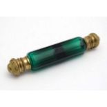 A Victorian double ended green glass scent bottle with gilded tops 5 3/4" long