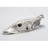 A novelty desk top paper clip / letter clip formed as a pike fish with glass eyes . 21stC.