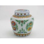 A small Chinese ginger jar and cover decorated with stylised peonies in a doucai style in green,