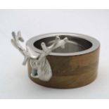 A silver plate and turned wood bottle coaster with stags head decoration. 21stC.