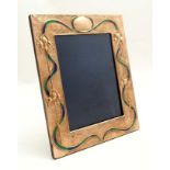 A copper photograph frame with embossed iris and enamel decoration in the Art Nouveau style.