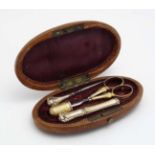 A late 19thC / early 20thC etui containing Continental gilt white metal needle / bodkin case,