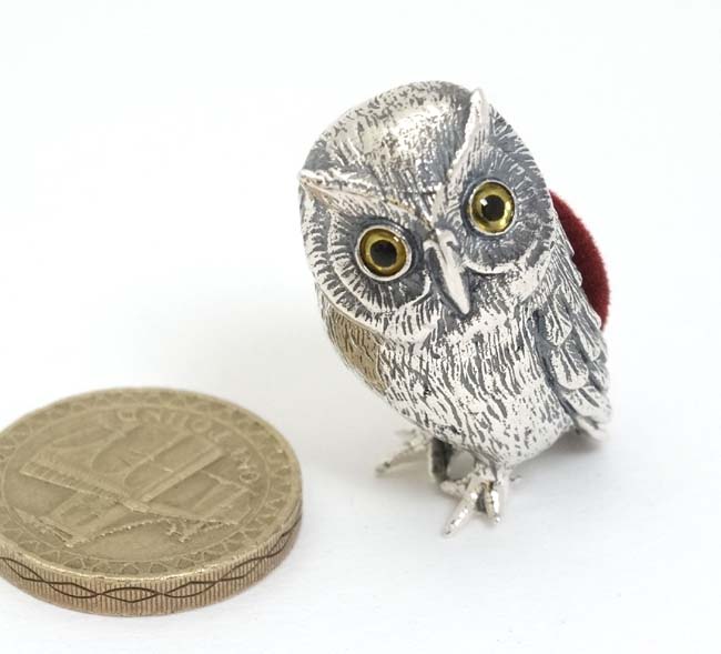 A novelty silver pin cushion formed as an owl.