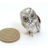 A novelty silver pin cushion formed as an owl.