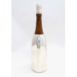 A novelty silver plate cocktail shaker formed as a bottle of champagne with wooden neck. 21stC.