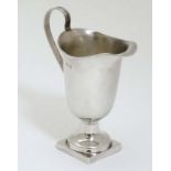 A silver cream jug with reeded handle hallmarked Birmingham 1903 maker Robert Pringle & Sons.