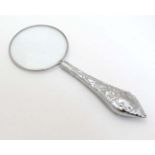 A magnifying glass with silver plate handle.