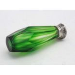 A green glass scent bottle with white metal top.