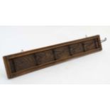 A set of early 20thC Continental folding wall mounted hooks 30" wide CONDITION: