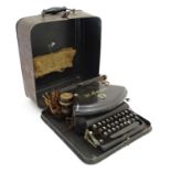 The Empire - Typewriter : A brown with gilt line tole-peint cased typewriter .