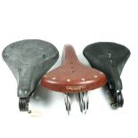 *Three Saddles, to include a Safety Bicycle type, a Dunlop and another (3)