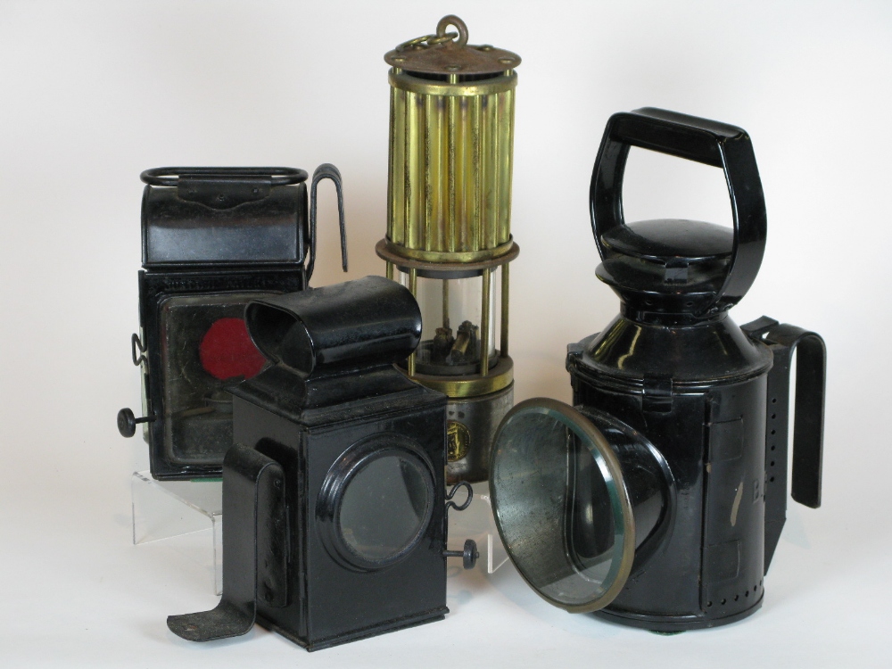 *Four oil-powered lamps. A Premier Lamp and Engineering Co. miner's safety lamp, having a threaded