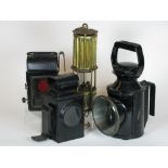 *Four oil-powered lamps. A Premier Lamp and Engineering Co. miner's safety lamp, having a threaded