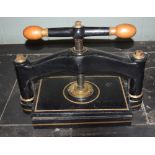 *Bookpress. A cast iron bookpress, with brass handles, platen size approximately 38 x 35cm (15 x