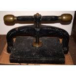 *Bookpress. A large cast iron bookpress, finished in black, with brass handle ends, platen