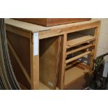 *Bench unit. A work bench of wooden construction, with chipboard top and shelving beneath,