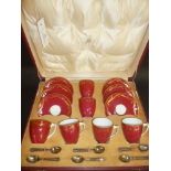 *Royal Worcester. A cased porcelain coffee set comprising 6 cups and saucers with red ground and