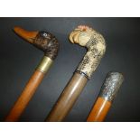*Walking canes. A Chinese Malacca cane with white metal top decorated with elders, 92cm, long