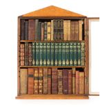 *Bookcase. A three shelf birdseye marple veneered glass fronted miniature bookcase, mid 19th