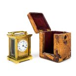 *Carriage clock. An Edwardian brass timepiece, with circular white enamel dial, black roman
